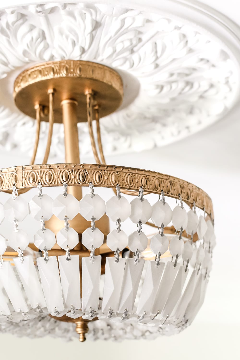 thrifted light fixture painted with Rub n Buff and frosted glass spray paint
