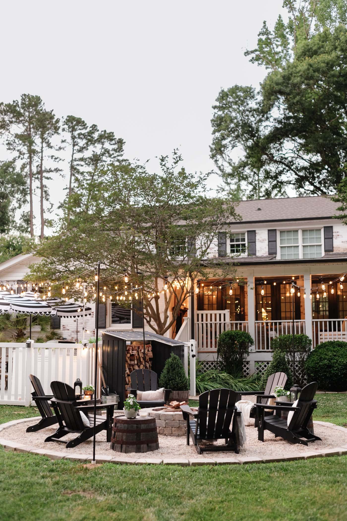 string lights around a fire pit in a backyard