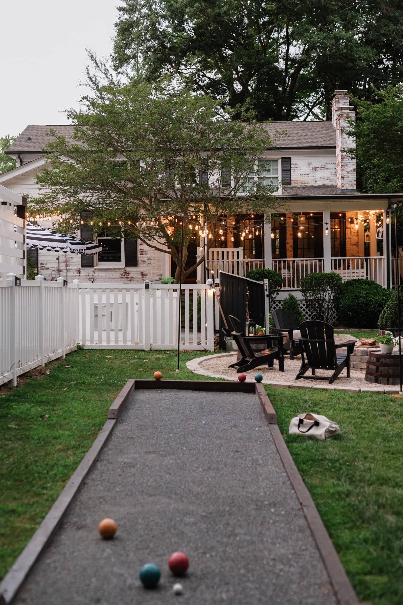 bocce ball court in a backyard with a fire pit