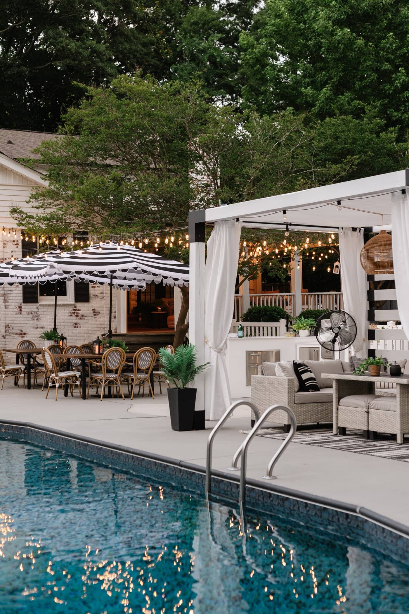 string lights around a backyard pool deck
