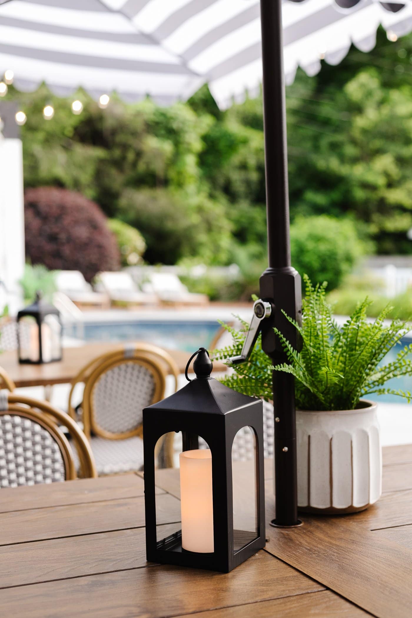 faux fern and lantern on a patio table