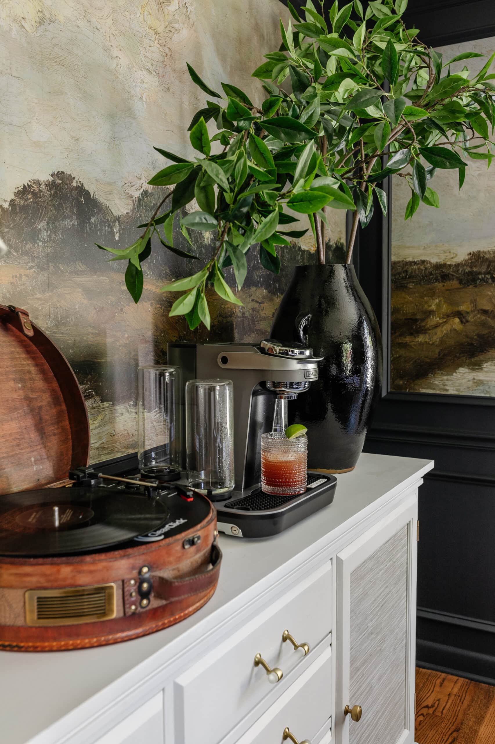 bartesian cocktail machine used on top of a dining room sideboard