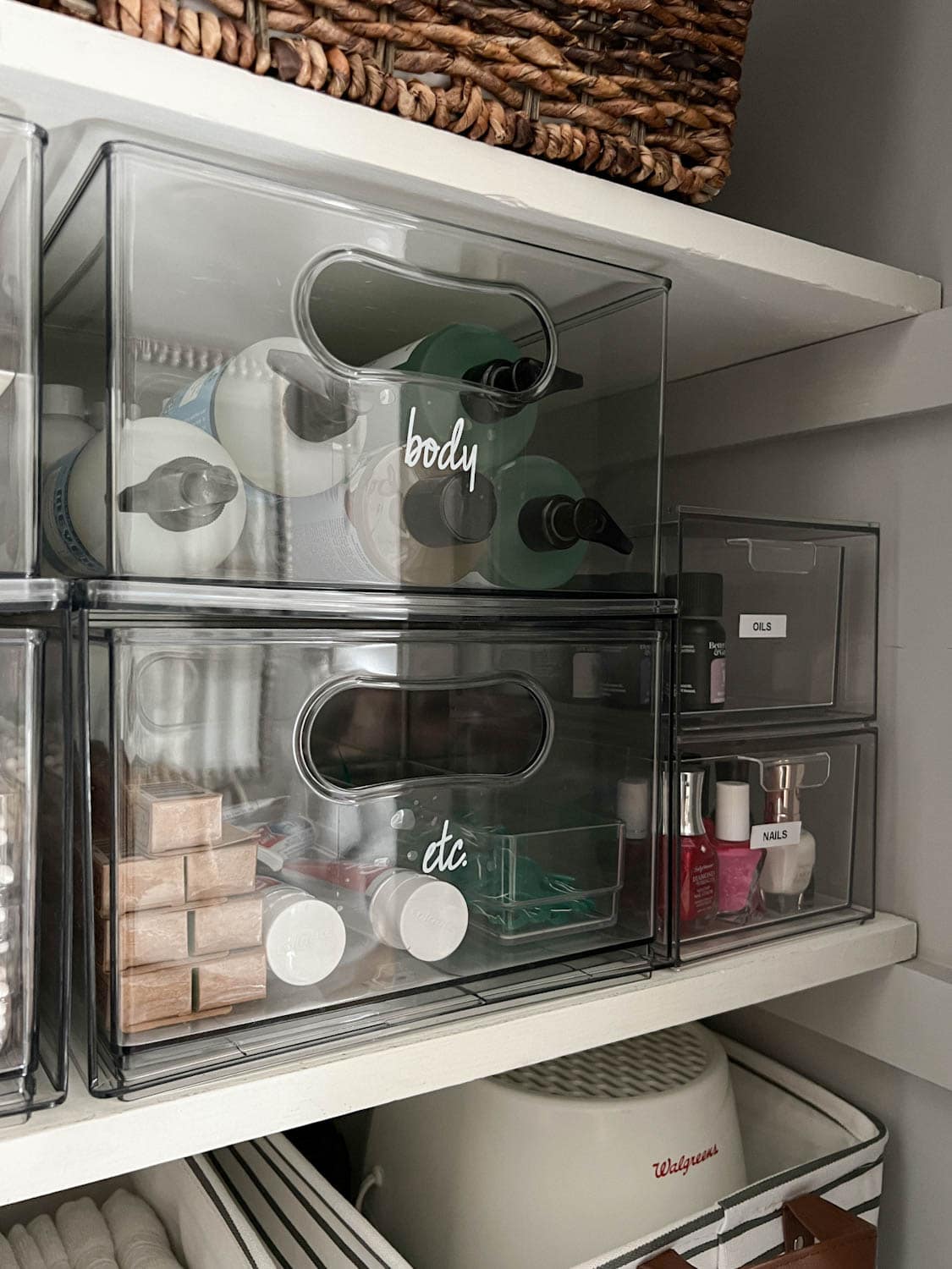 clear storage bins with labels for bathroom supplies
