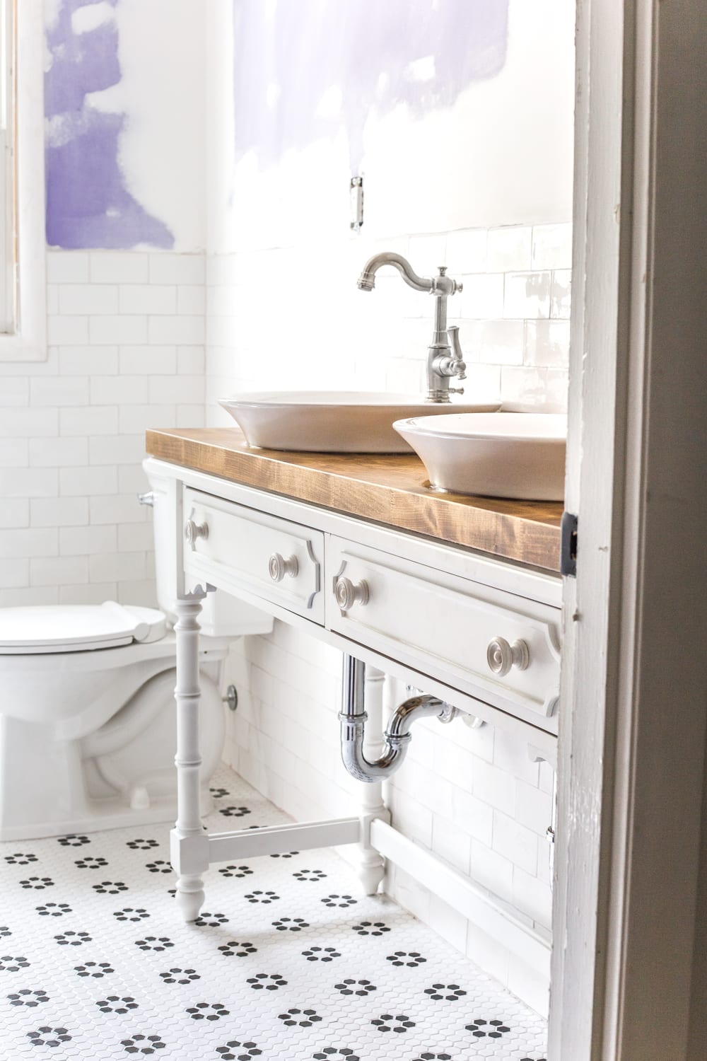 How to Turn a Console Table Into a Bathroom Vanity | blesserhouse.com - A tutorial for how to reconstruct a console table to repurpose as a bathroom vanity and leave drawers functional underneath sinks. 