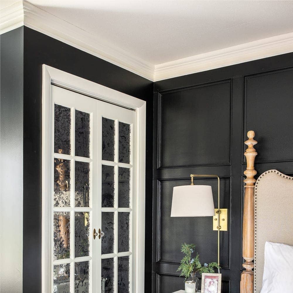 black bedroom with white doors and crown