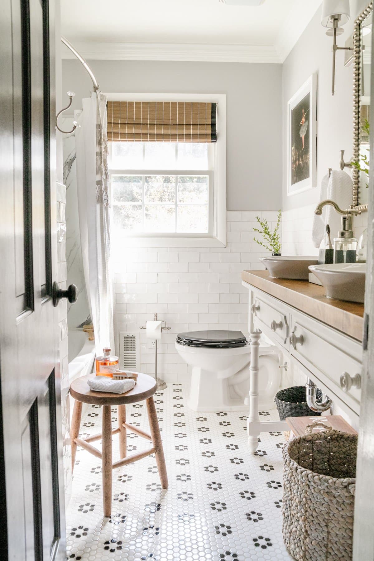 small bathroom with subway tile on walls and penny tile on floor