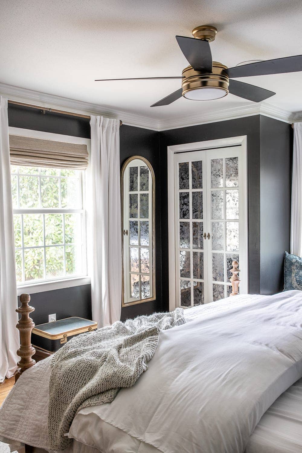 velvet curtains from Half Price Drapes and Roman shade in bedroom with black walls