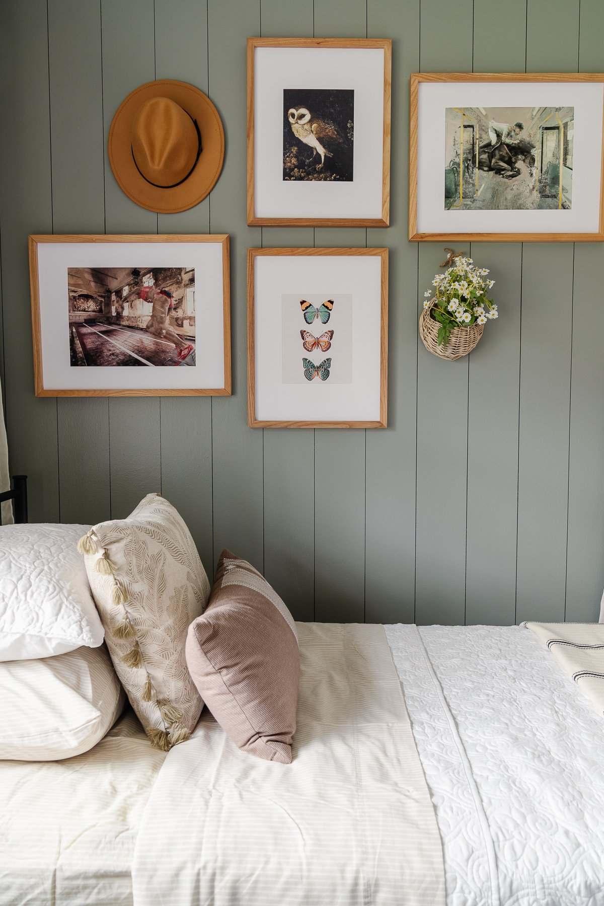 gallery wall above a bed