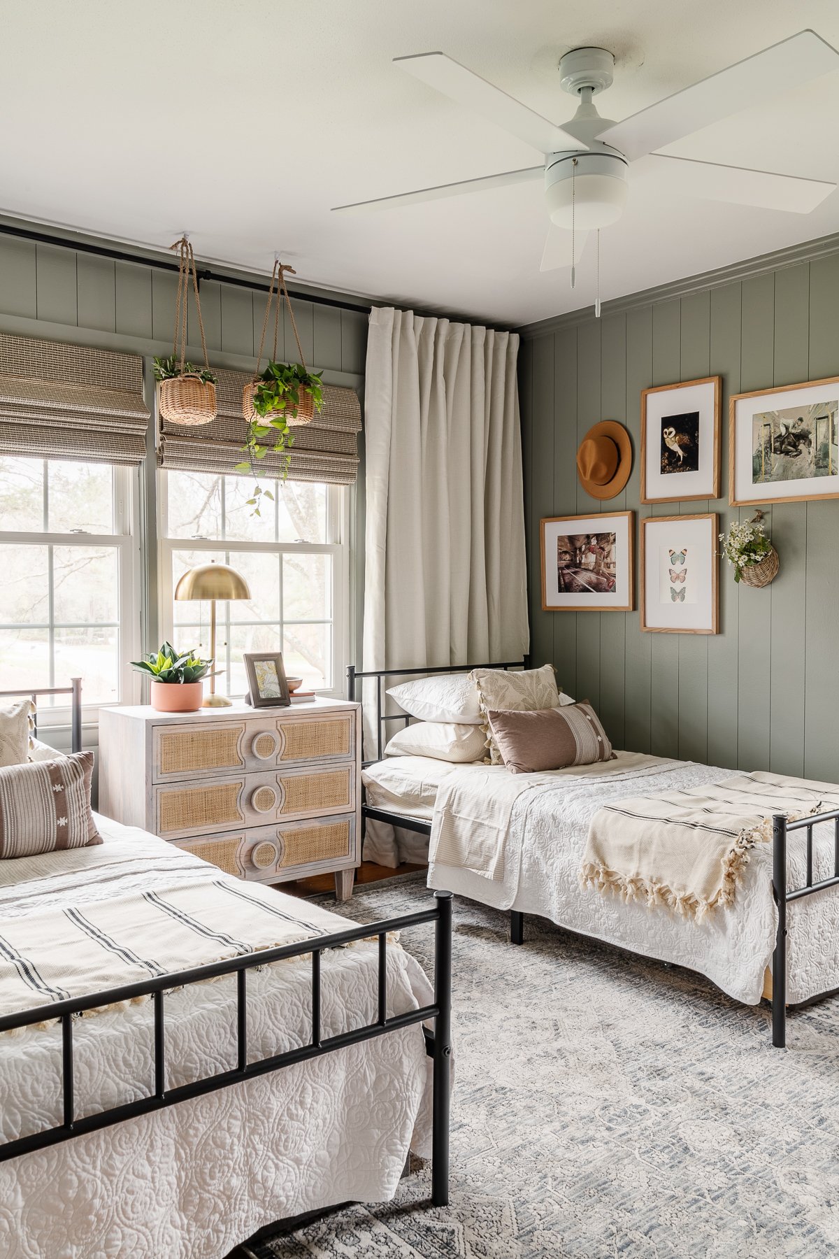 small bedroom with twin sized beds in front of a window