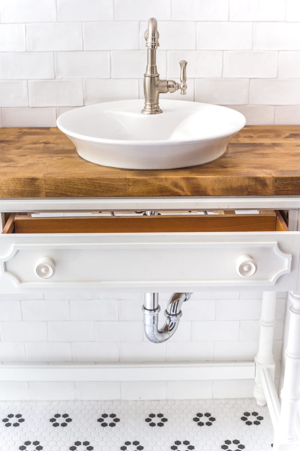How to Turn a Console Table Into a Bathroom Vanity | blesserhouse.com - A tutorial for how to reconstruct a console table to repurpose as a bathroom vanity and leave drawers functional underneath sinks. 