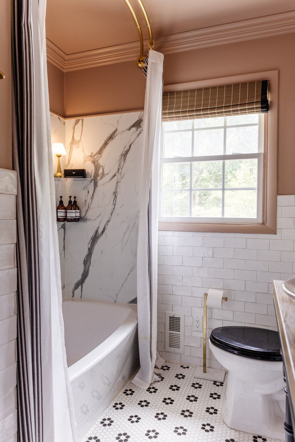blush pink bathroom with waterproof lamp in shower