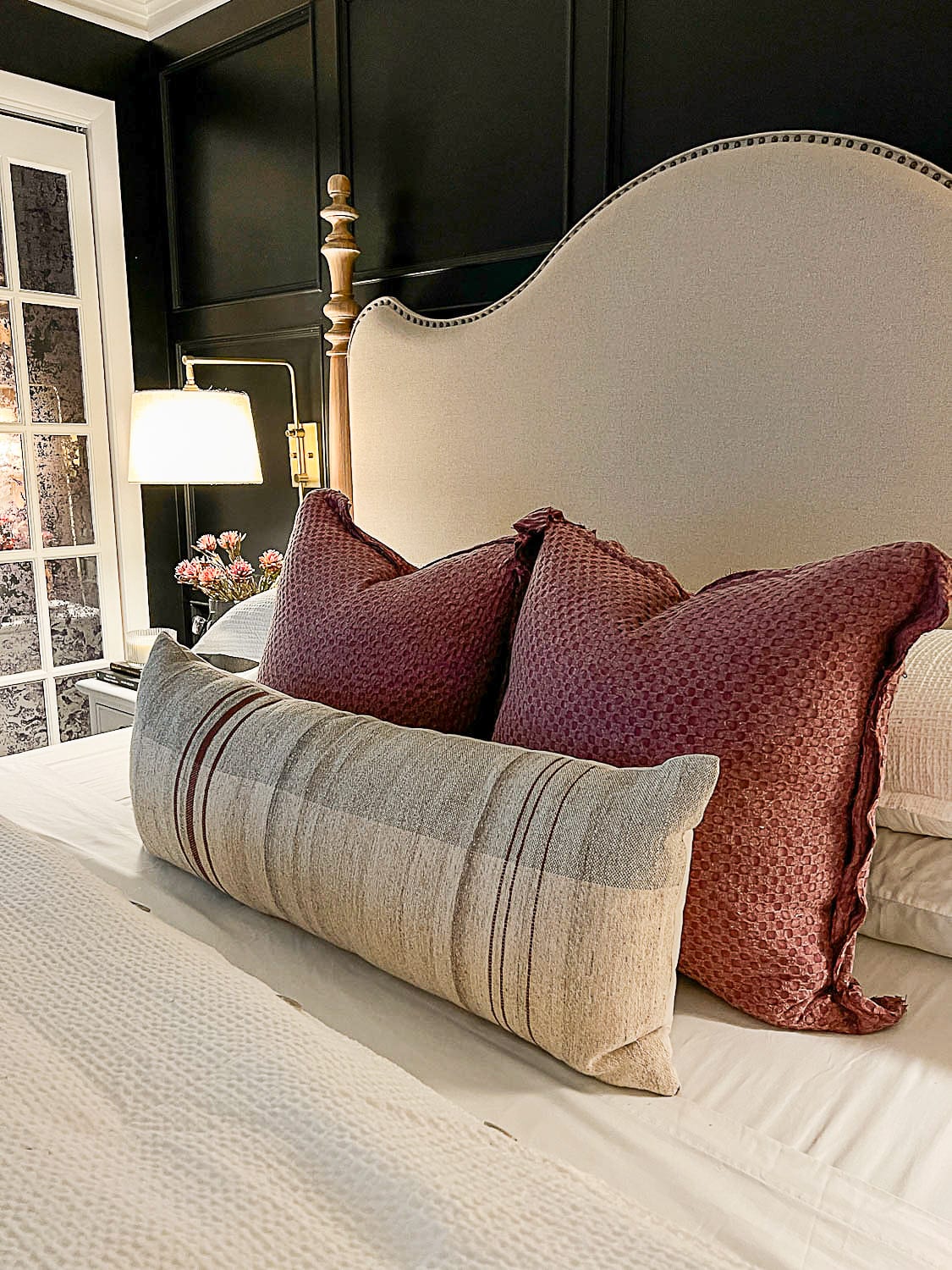 fall pillows on bed with lamp light