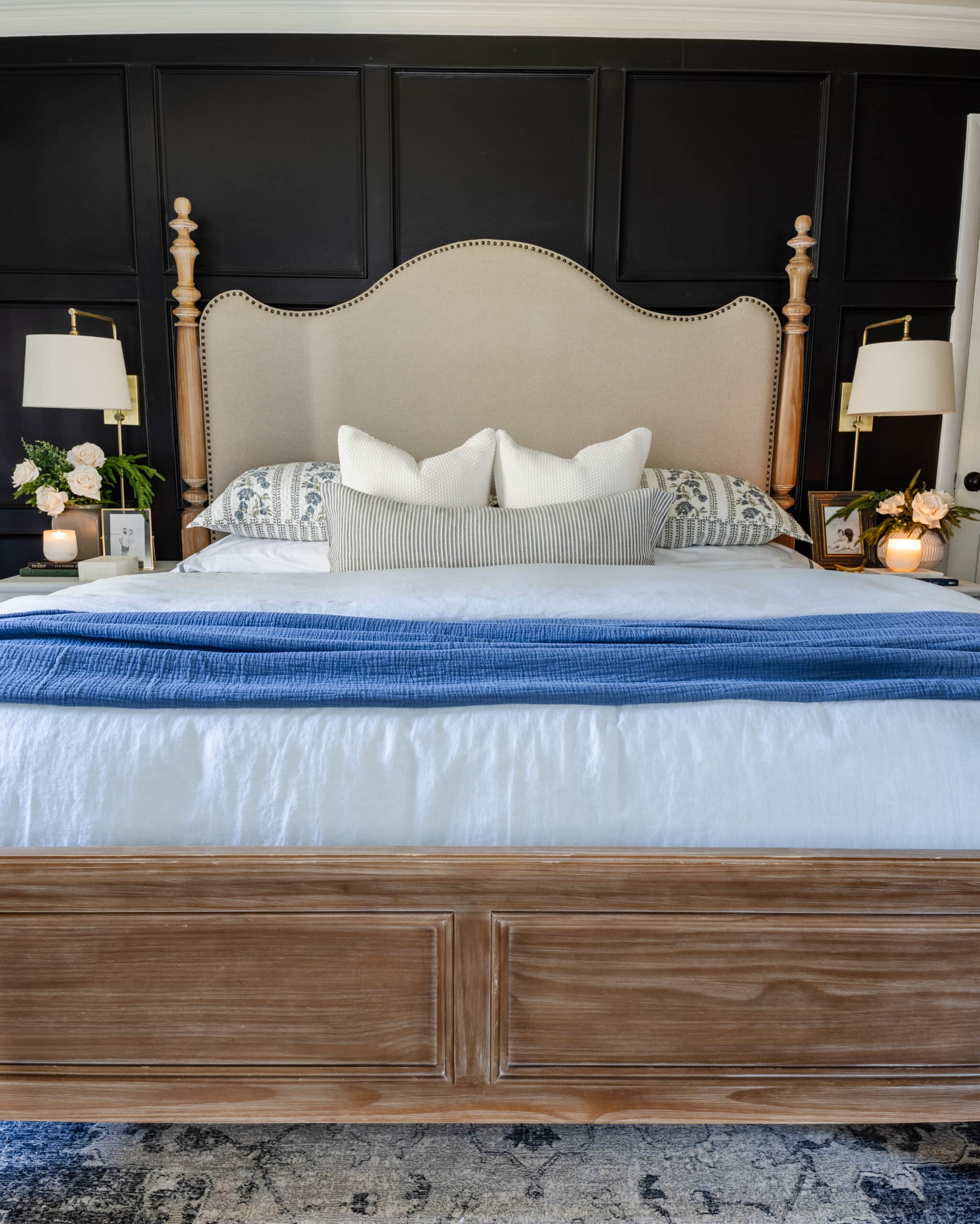Black bedroom painted KILZ Rebel with upholstered wood poster bed and blue bedding