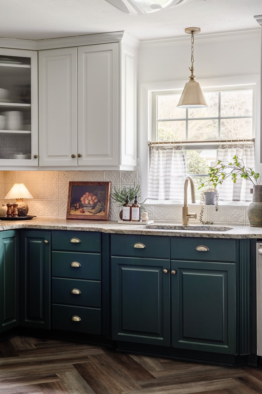 white and green kitchen cabinets with mini lamp on countertop
