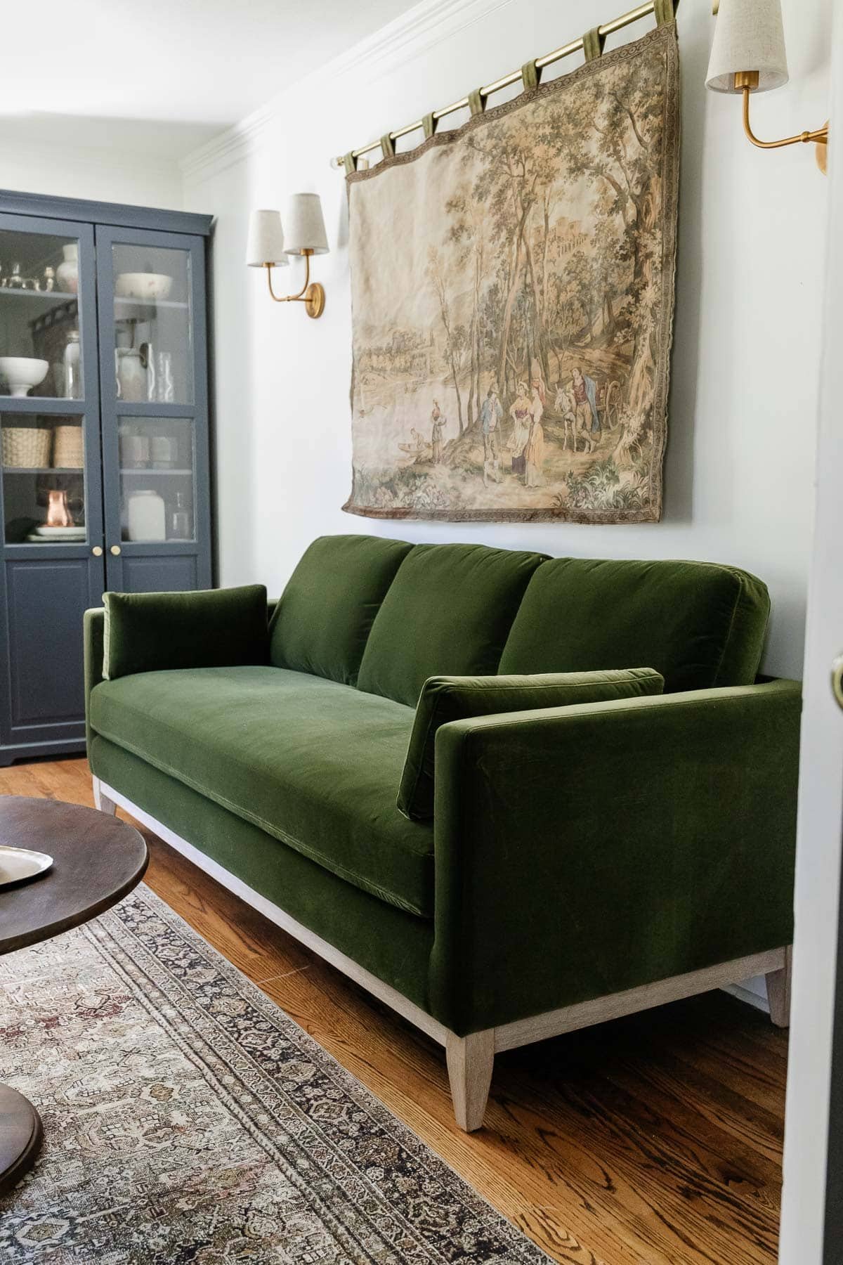 modern farmhouse green velvet sofa in an office