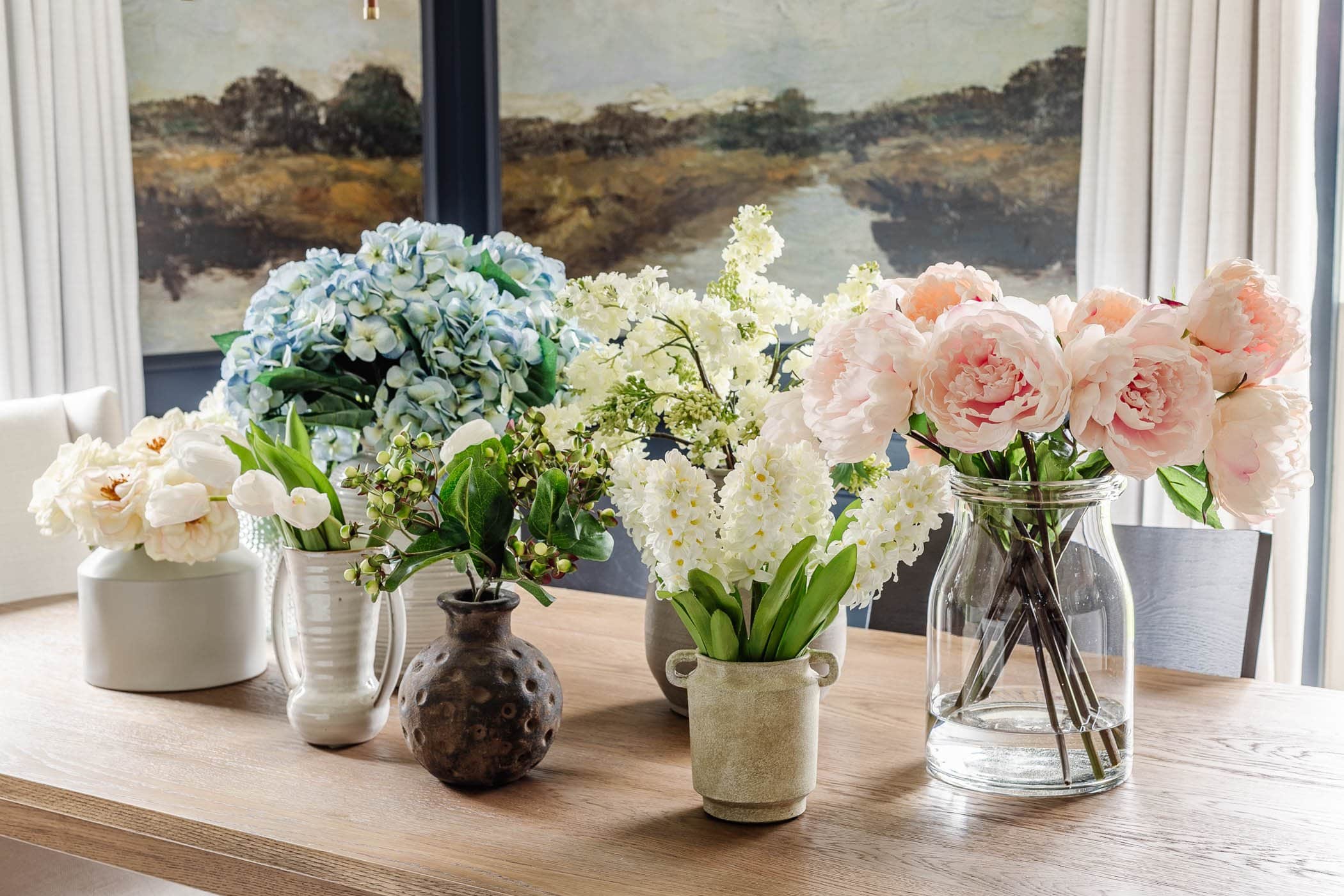 fake flowers in vases on a table