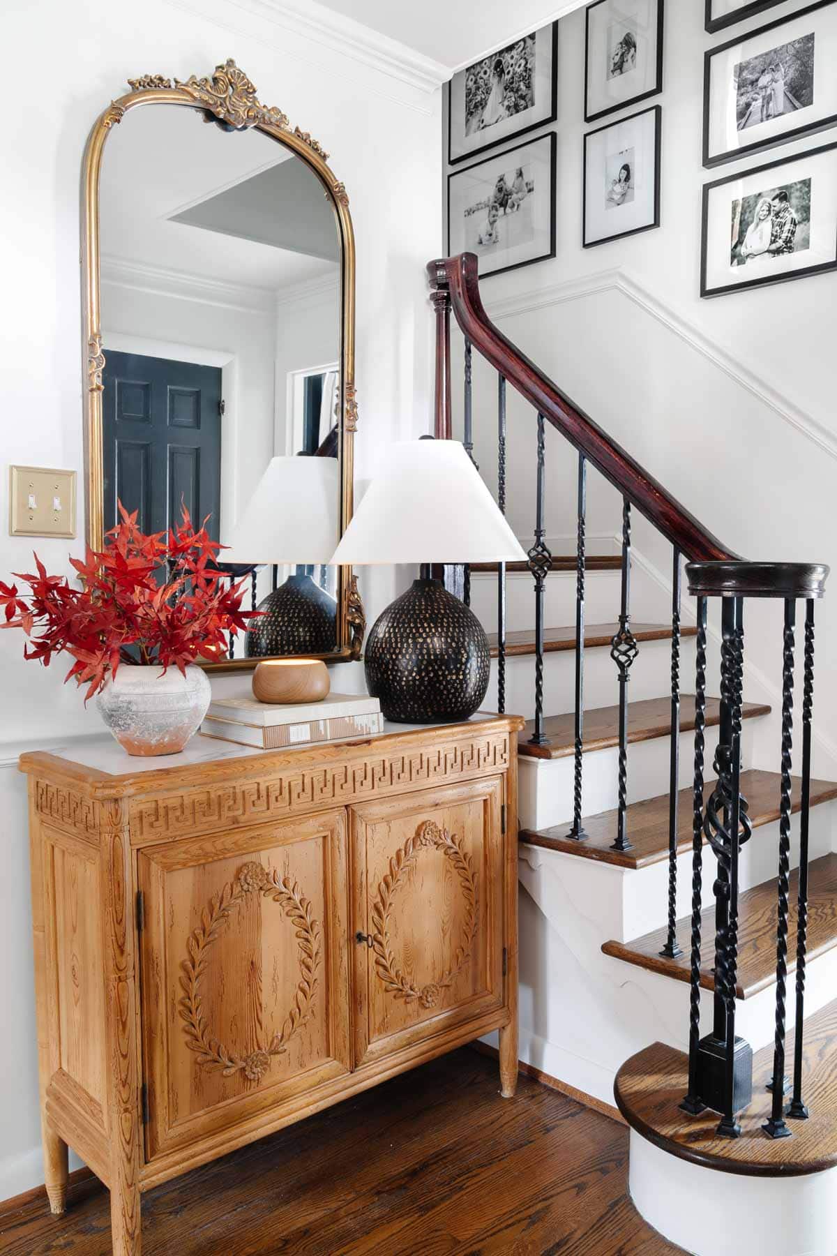 vintage credenza in foyer with gilded mirror