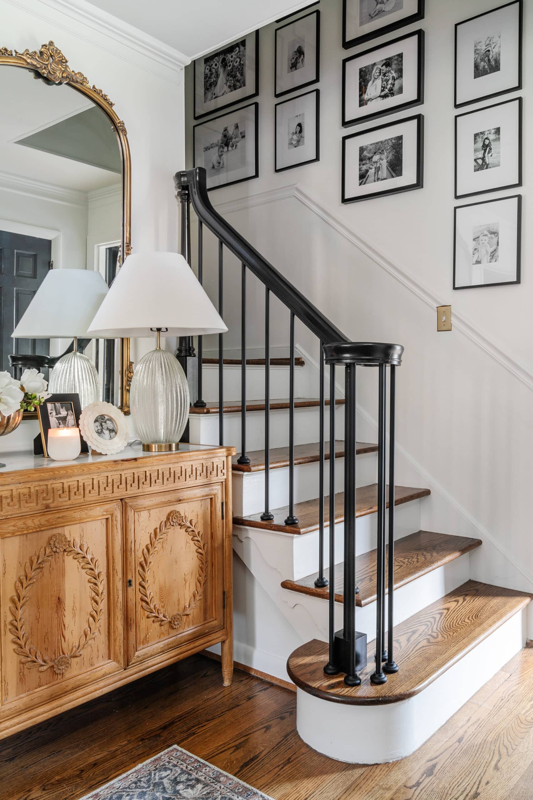 staircase gallery wall with black and white family photos