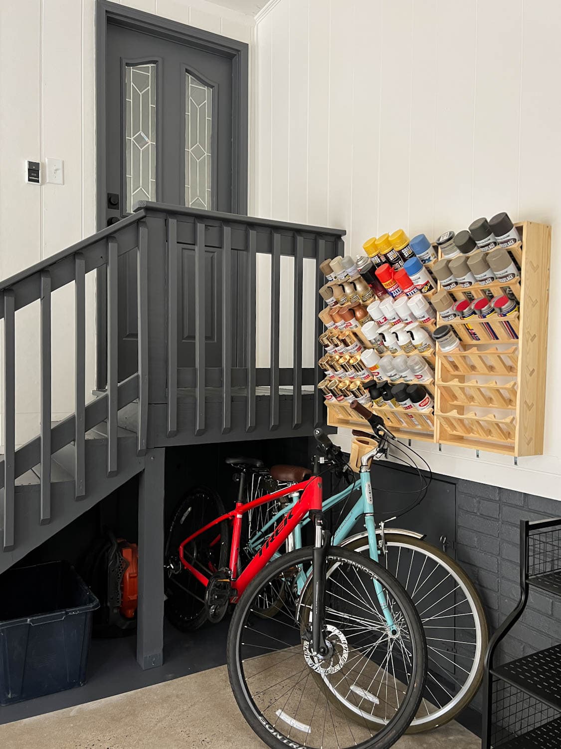 paint can storage rack and bikes in a garage makeover