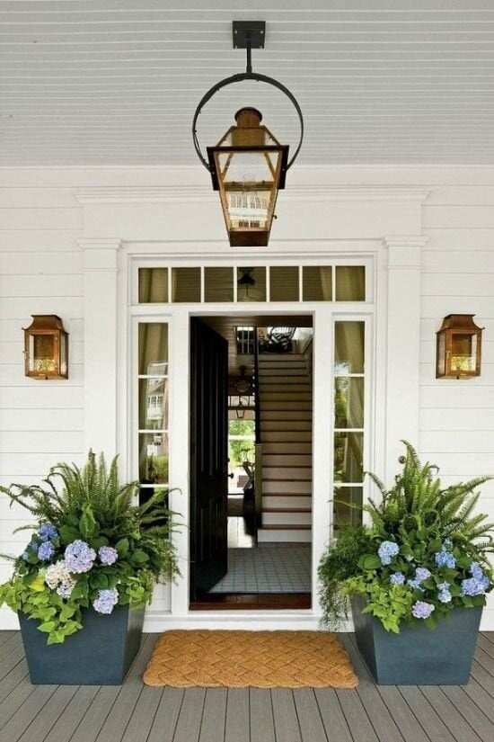 southern living front porch curb appeal with lanterns and potted ferns