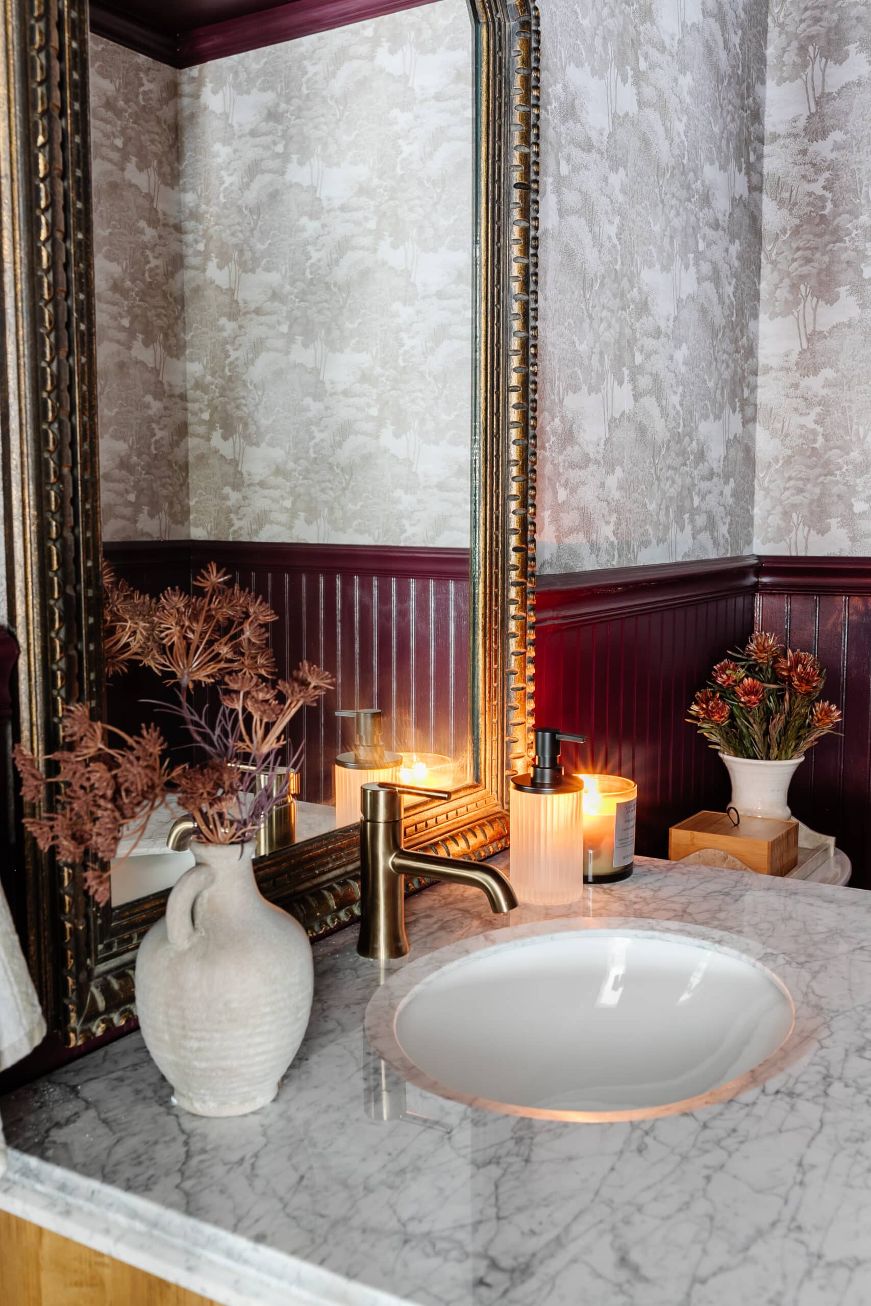 bathroom vanity decor with vintage mirror