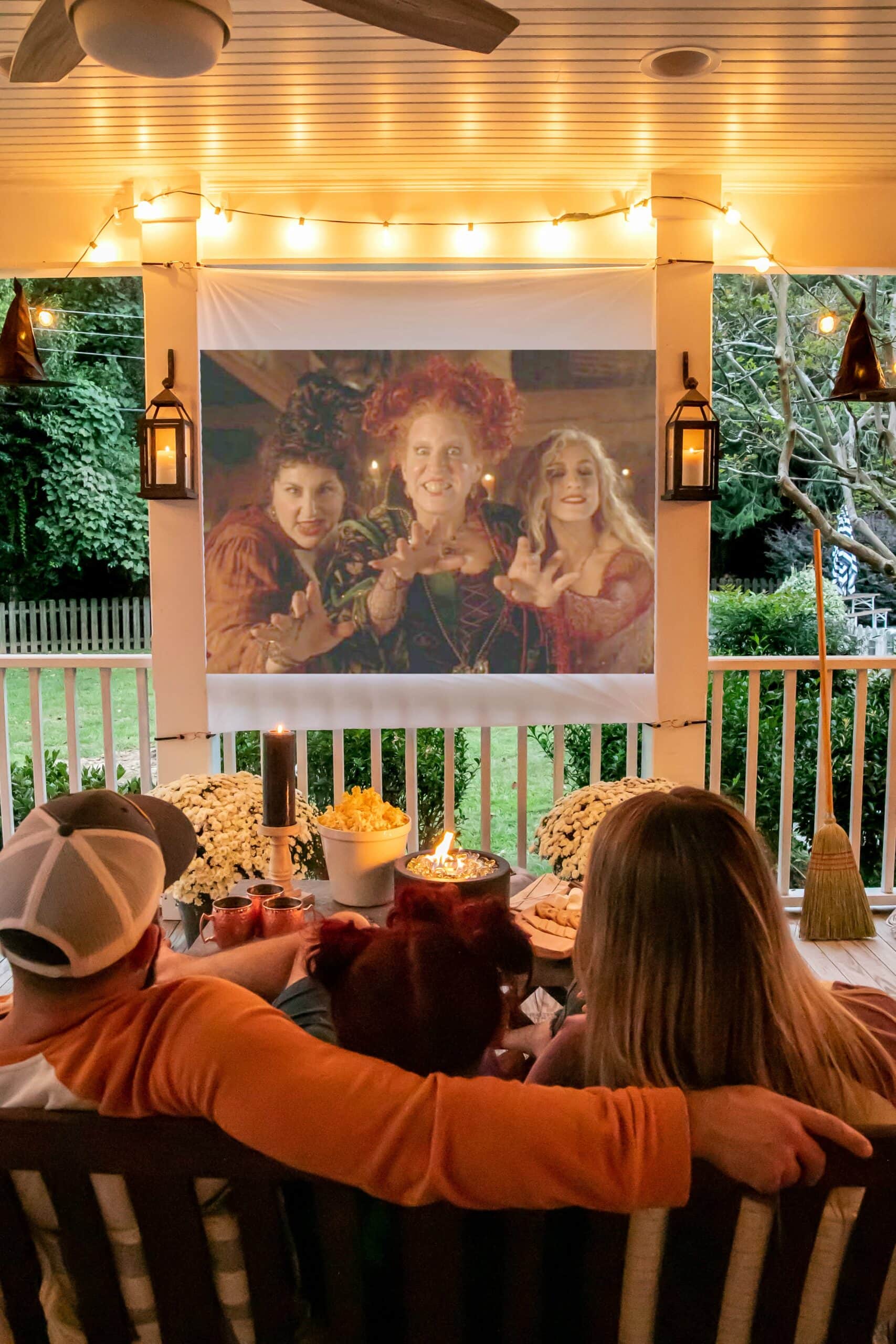 outdoor movie on back porch with fall decor