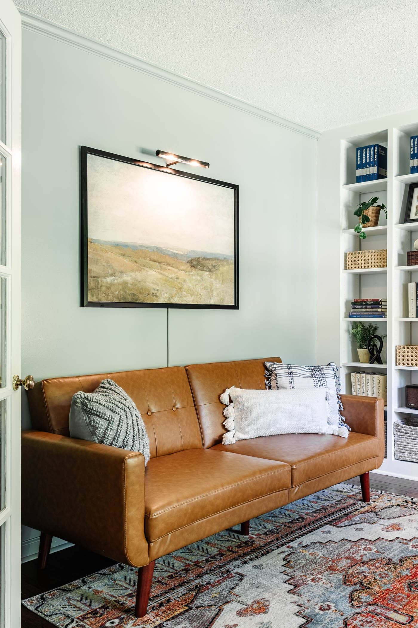 home office painted Benjamin Moore Boothbay Gray with leather futon