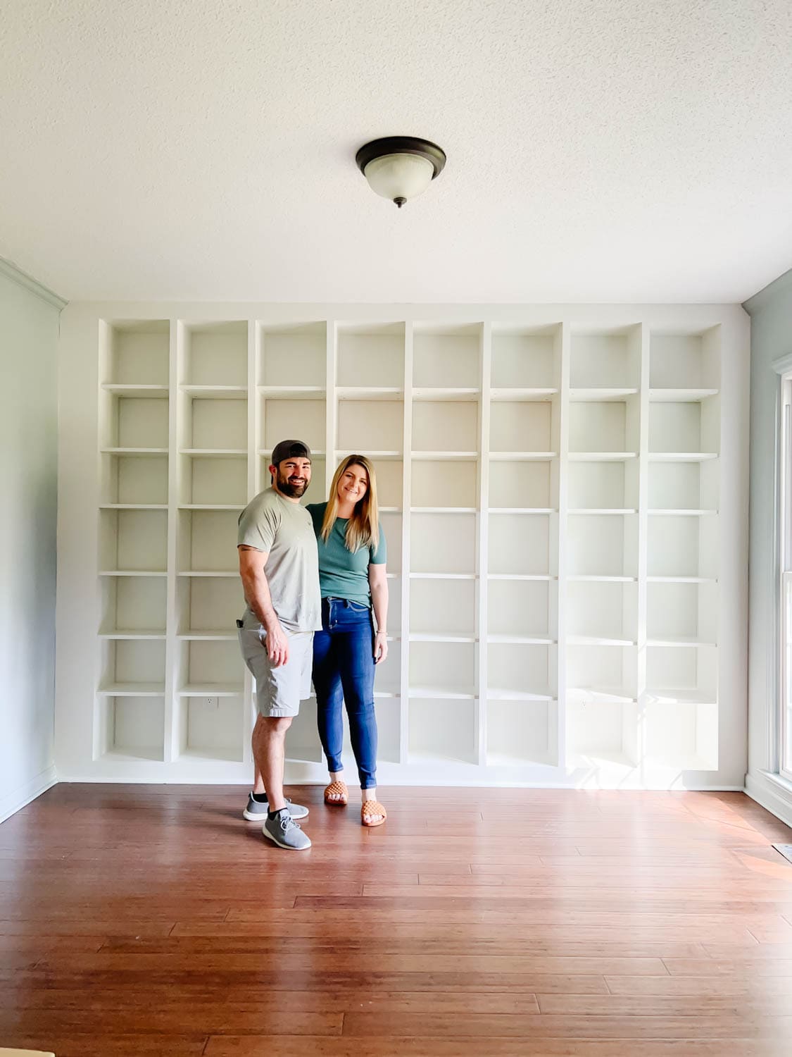newly painted IKEA Billy bookcase shelves to make them look like one solid built in piece