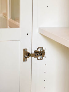 attaching hinges and hardware to doors to hang on bookcase