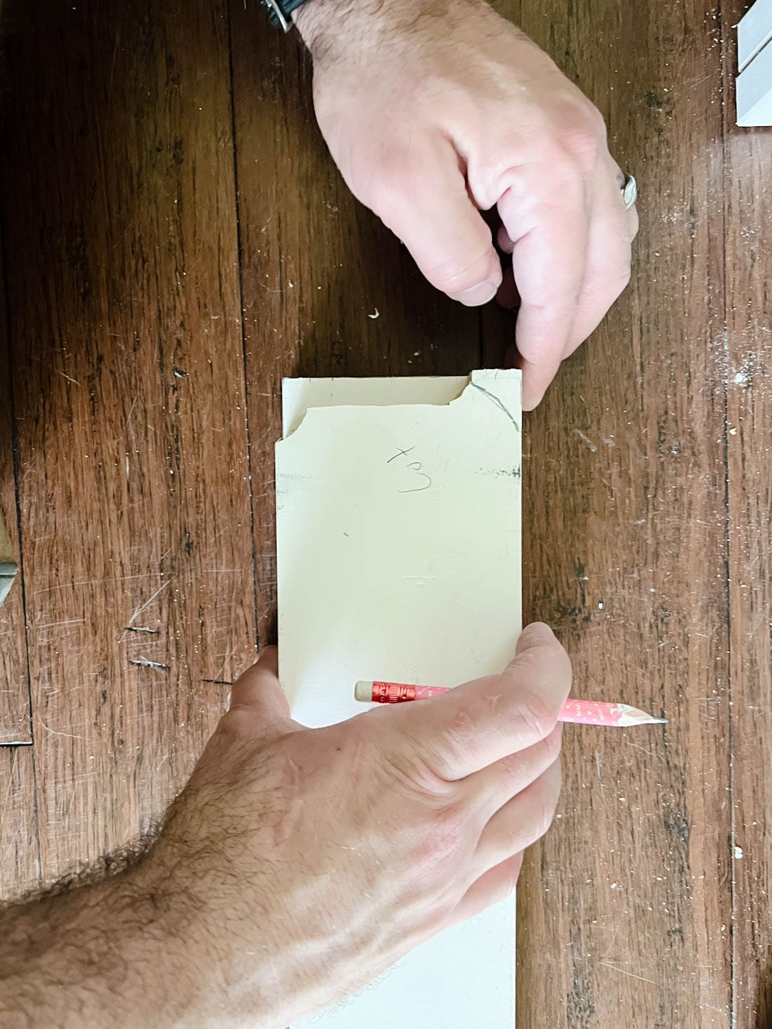 marking the shape of a baseboard to a 1x4 board to cut