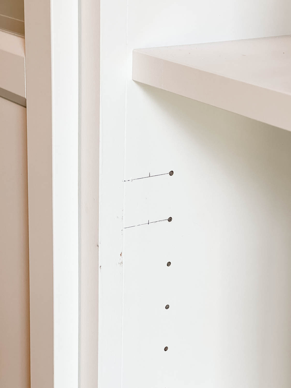 new holes marked for drilling to hang shelf doors