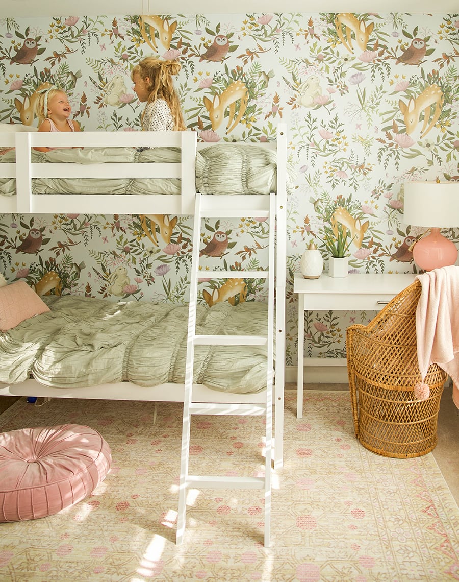 woodland wallpaper in girls shared bedroom 