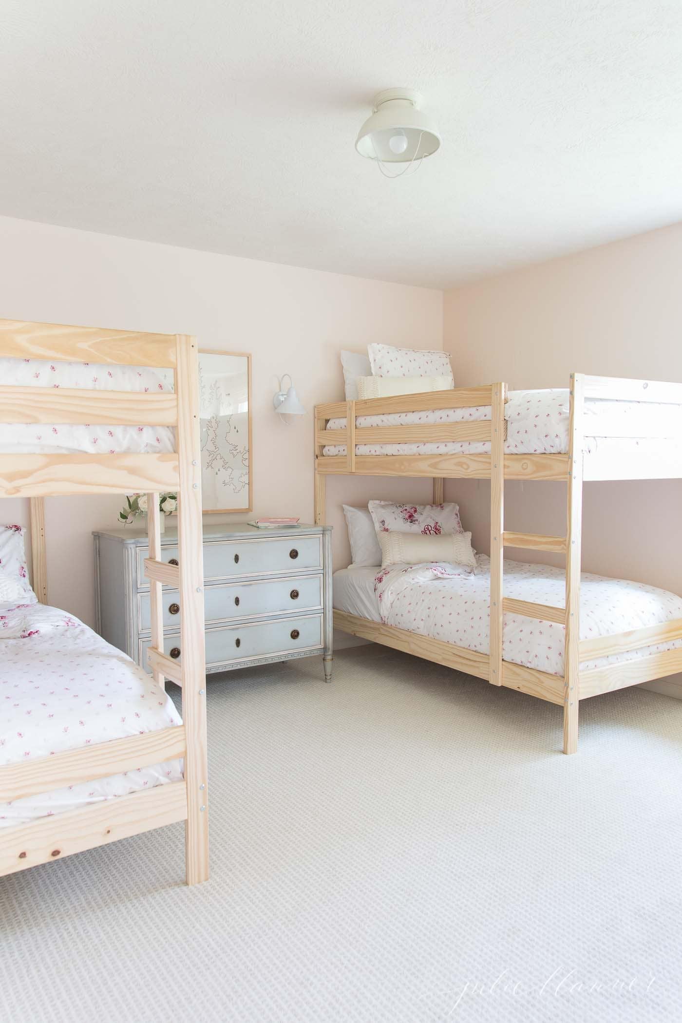 blush pink shared bedroom for 4 people with 2 bunk beds 