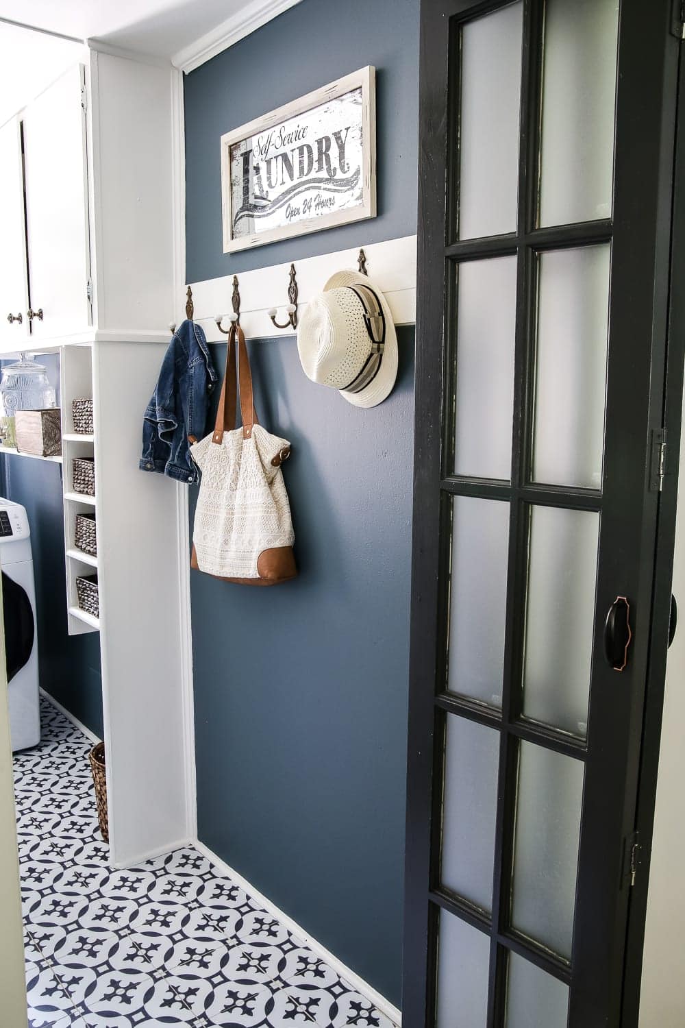 a diy wall decor idea to add hooks to a laundry room for organization
