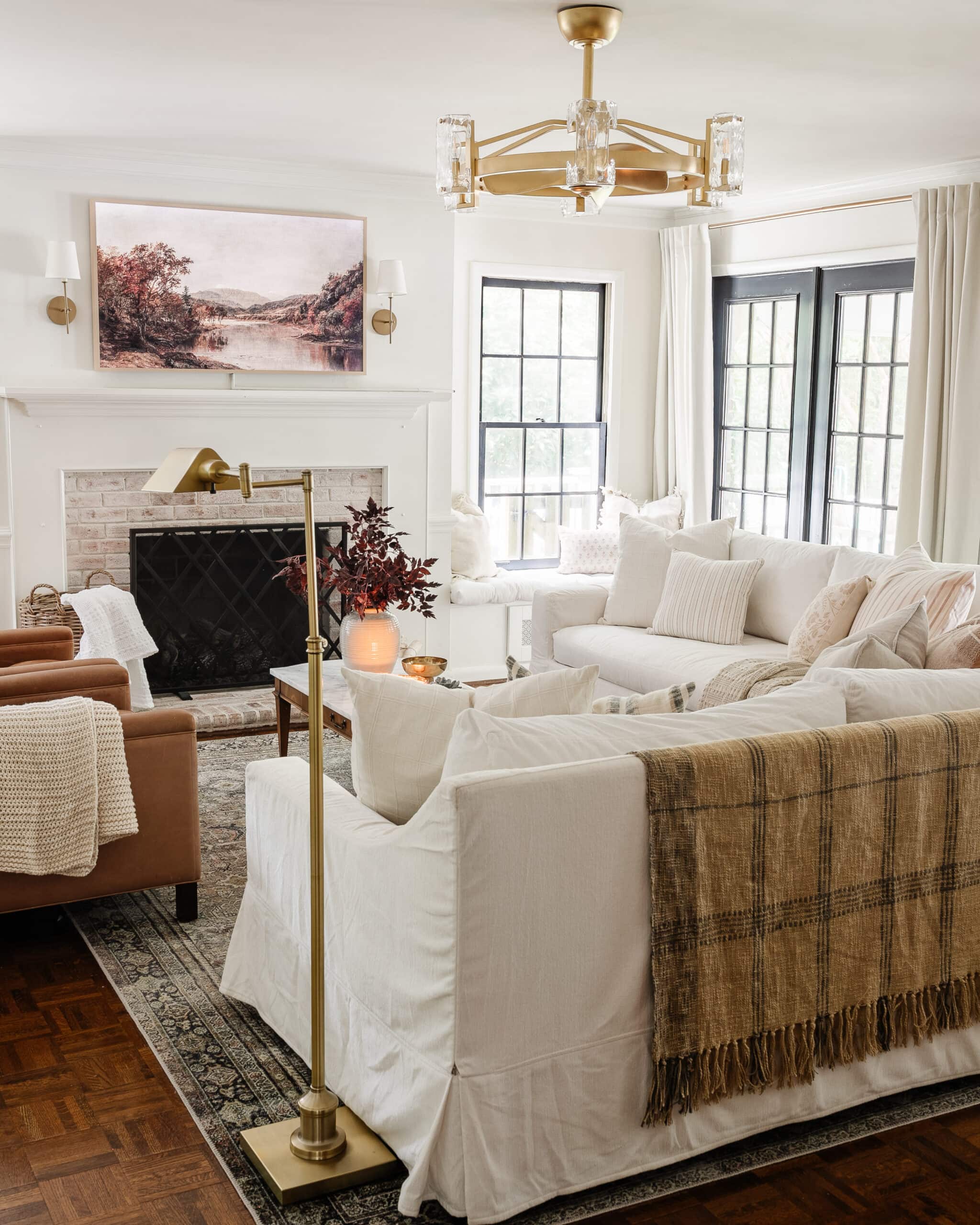 monochromatic living room with white sofas, white walls, and white curtains