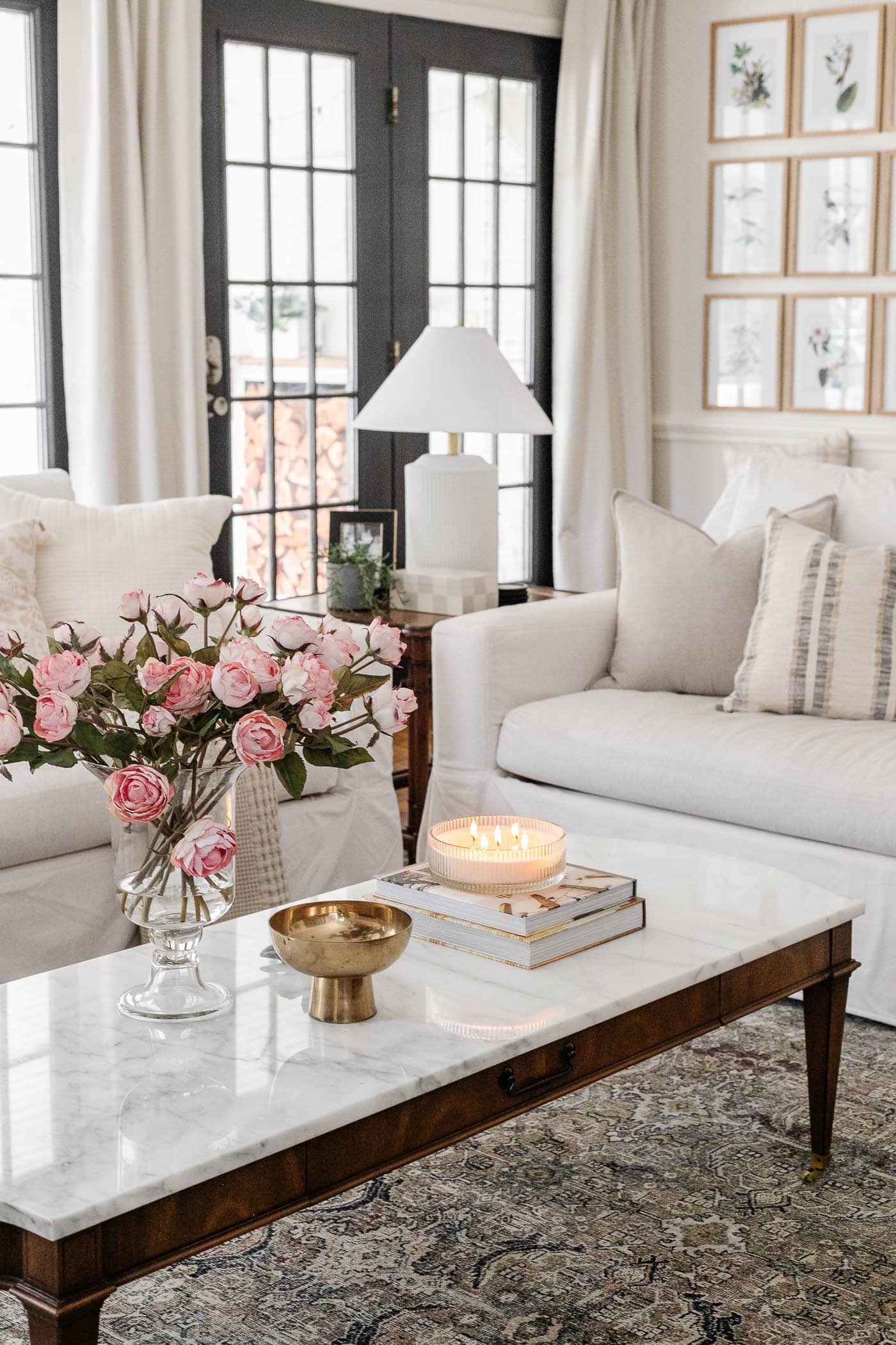 spring decorating in the living room with faux roses and fluted candle