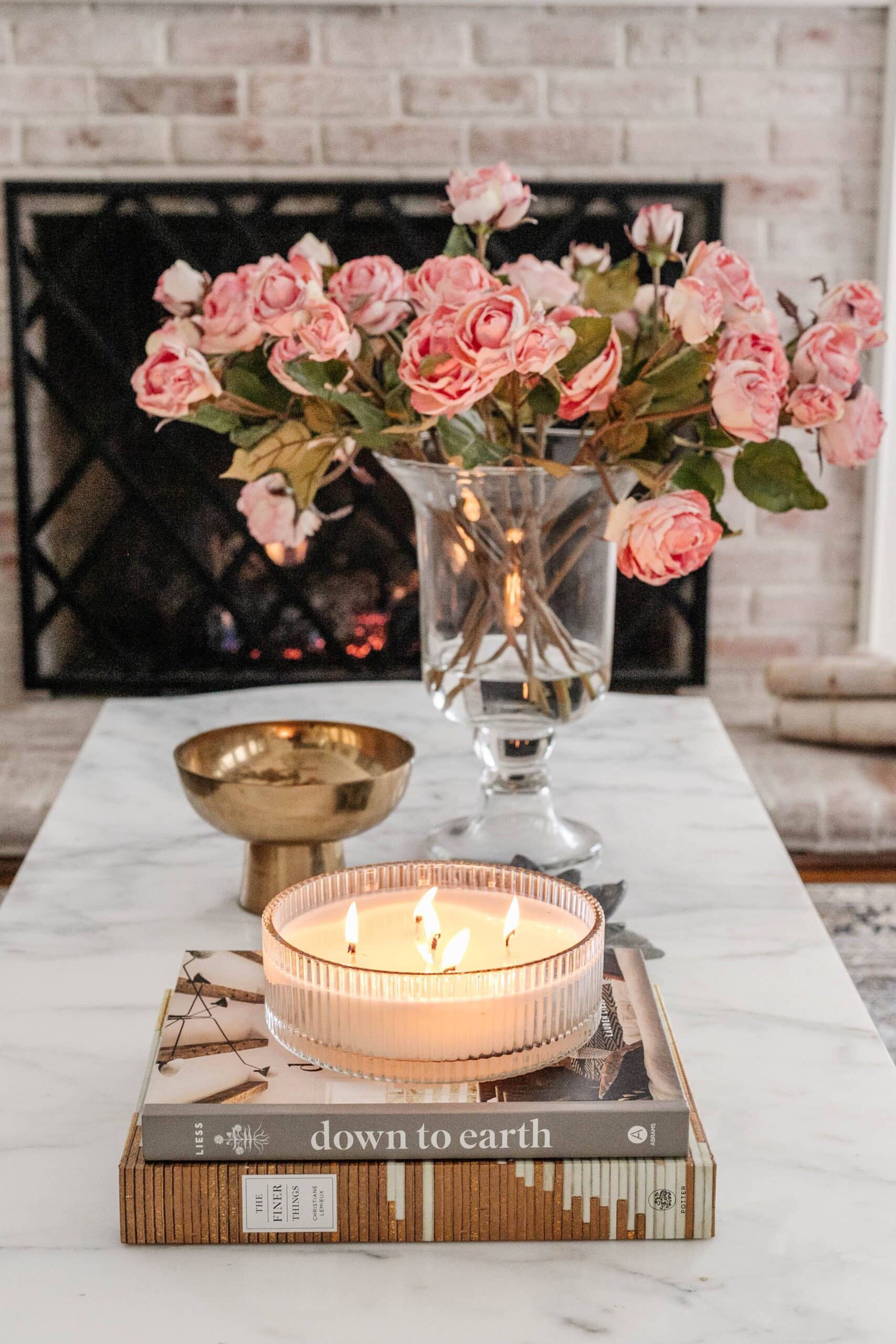 fake roses in a vase with water on a coffee table