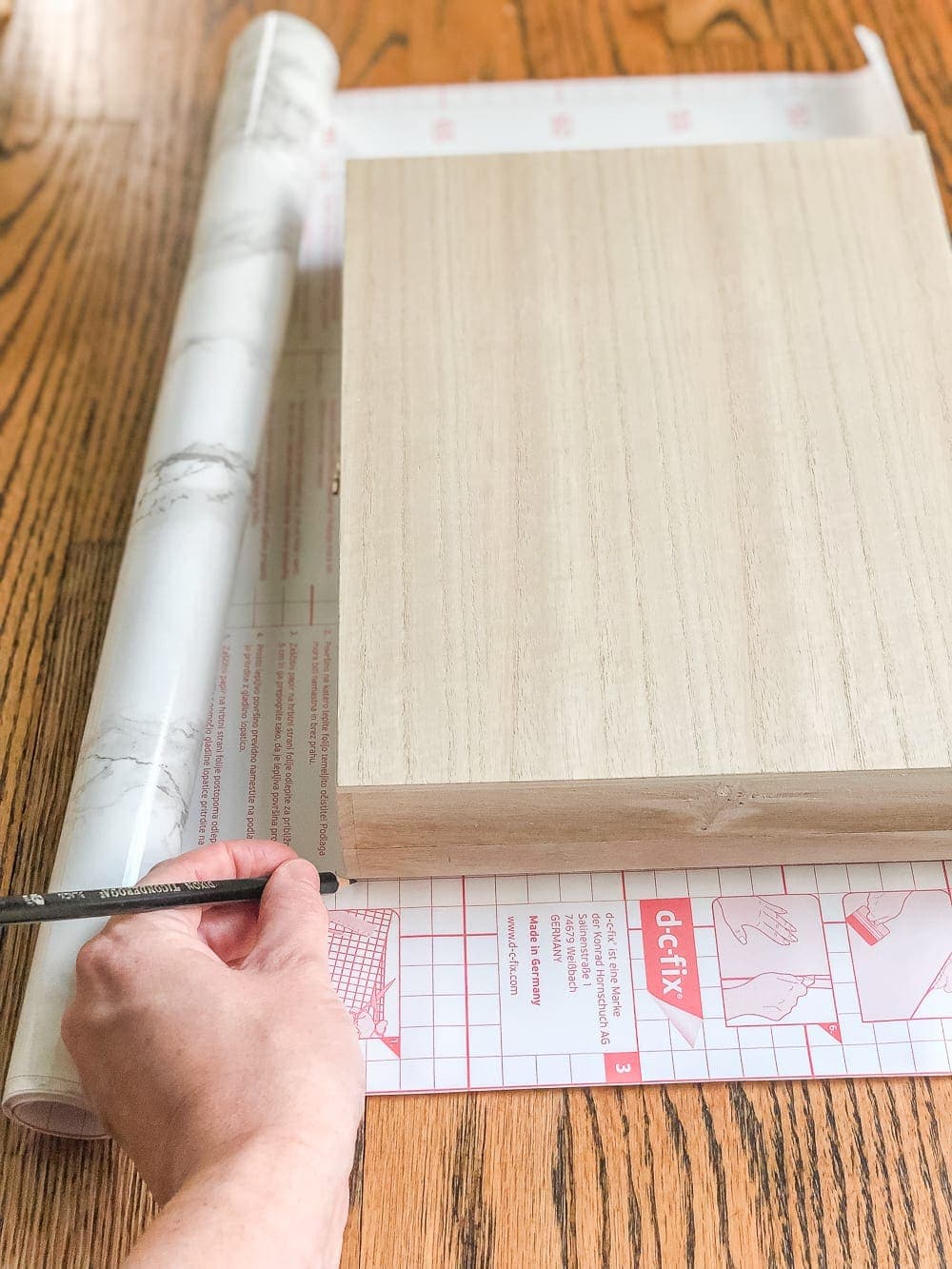 How to wrap a cigar box with contact paper to repurpose into a decorative remote control holder for a coffee table. #remotecontrolholder #coffeetabledecor