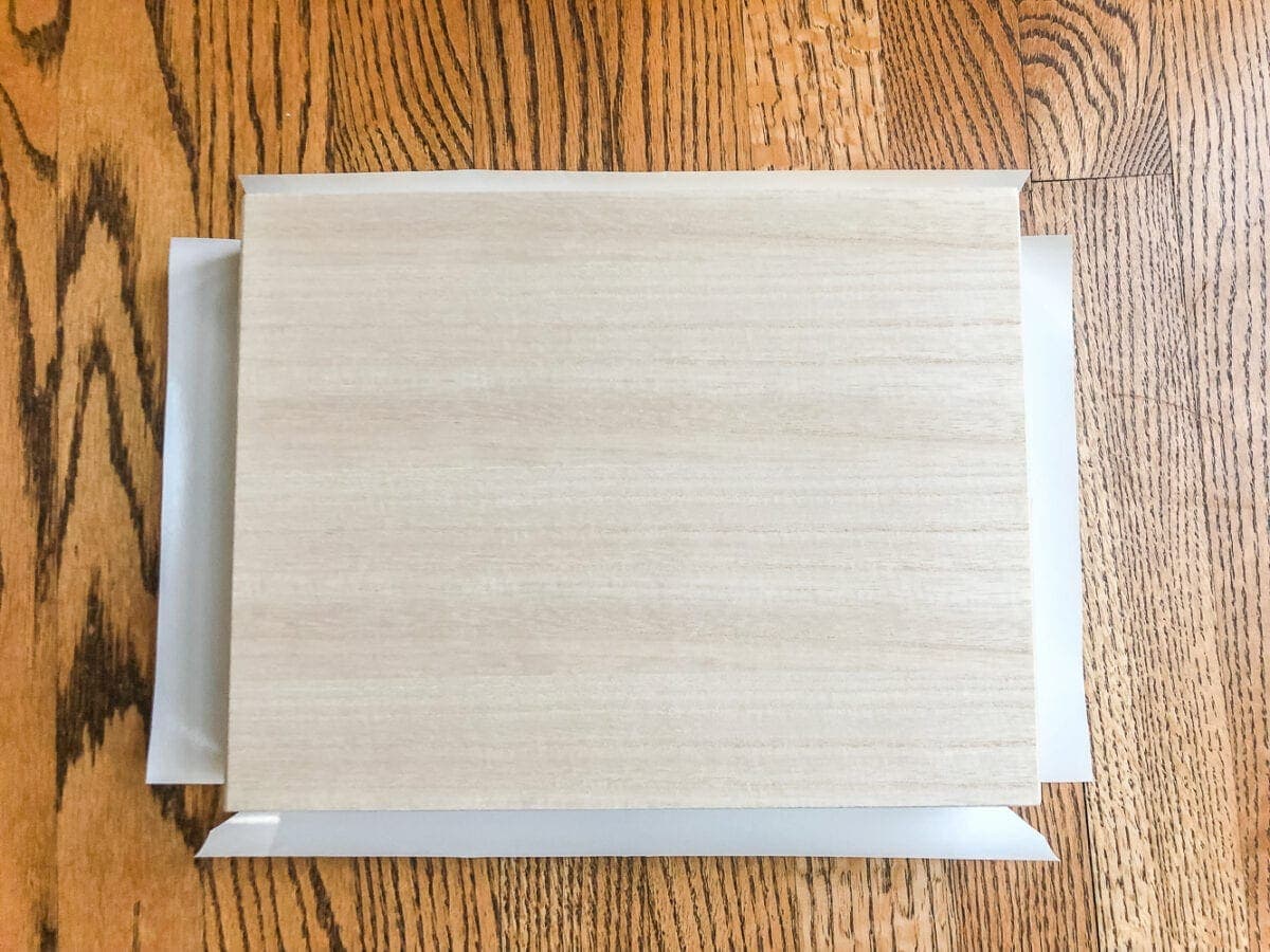 How to wrap a cigar box with contact paper to repurpose into a decorative remote control holder for a coffee table. #remotecontrolholder #coffeetabledecor