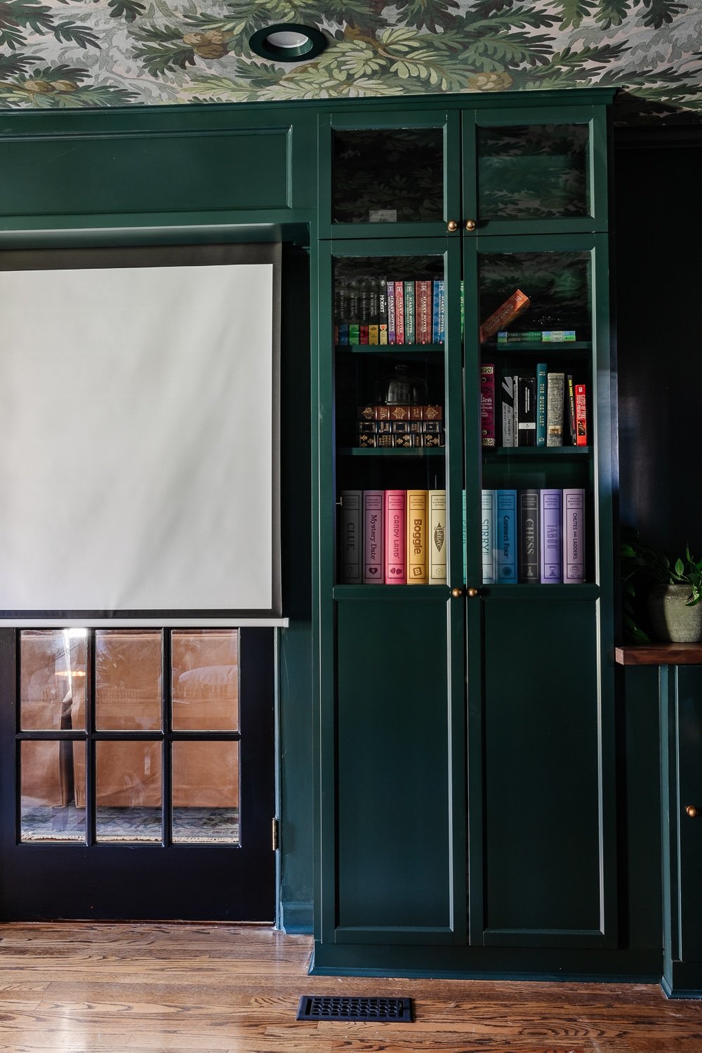 IKEA billy bookcase built in with glass front oxberg doors and motorized movie screen