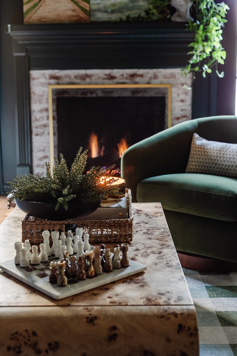 media room coffee table decor with chess set and tray in front of fireplace