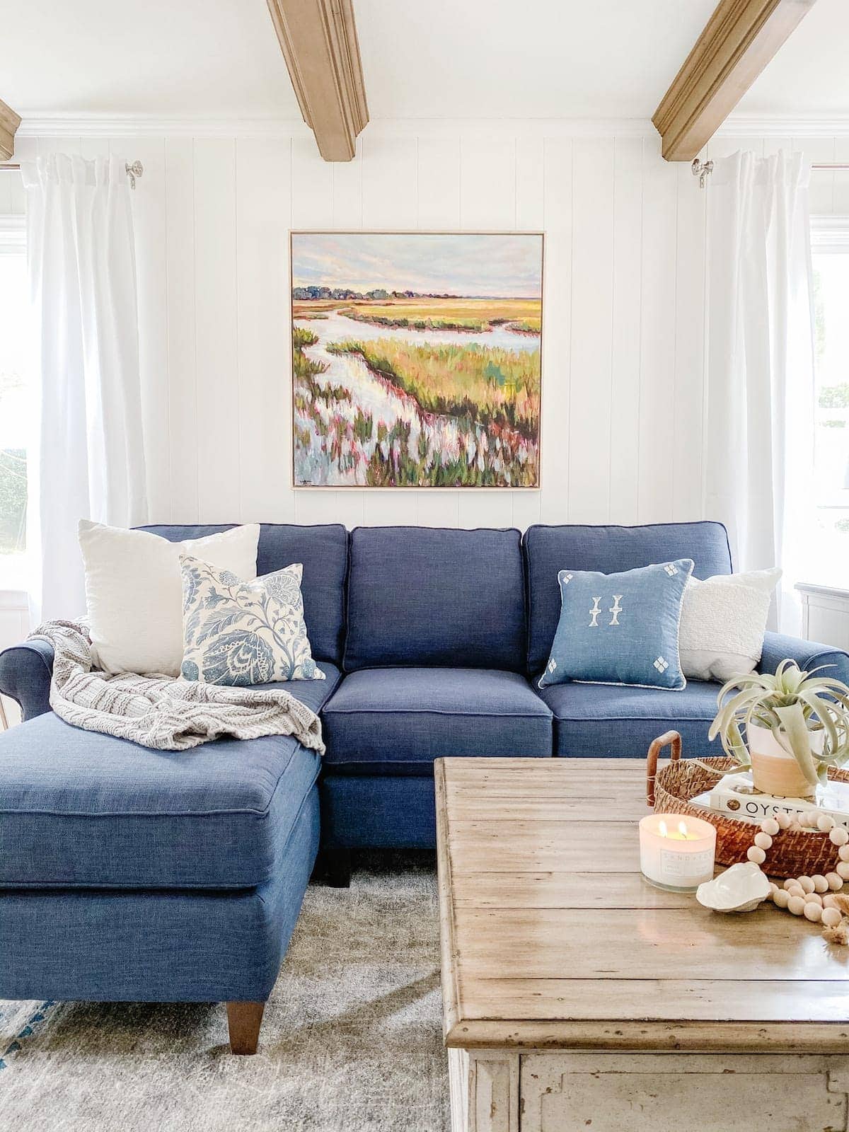 white coastal style living room with blue sectional