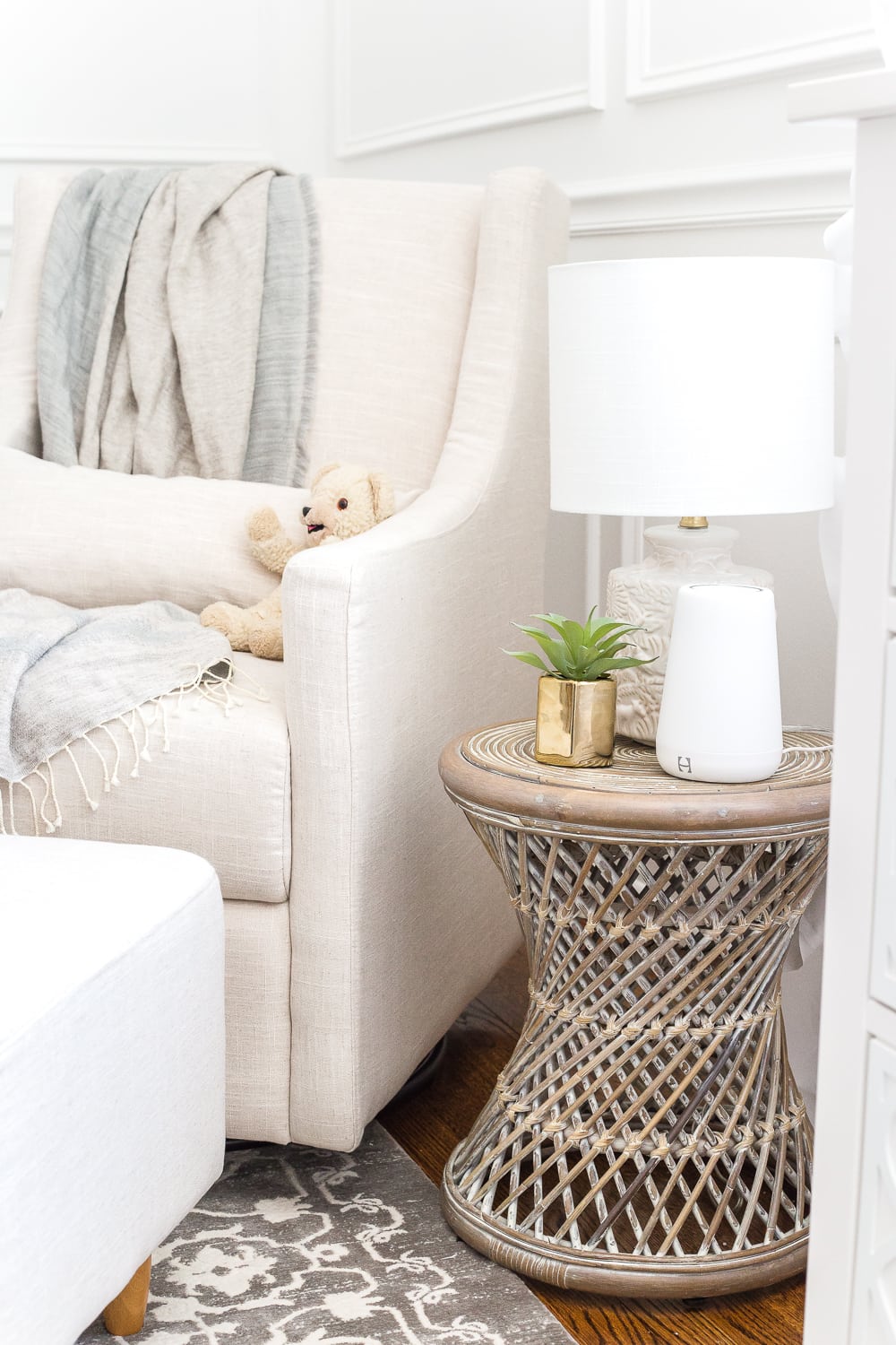 Nursery organization | Keep a side table beside a glider with a lamp that has a sleeper bulb (to promote sleep) and a sound machine.