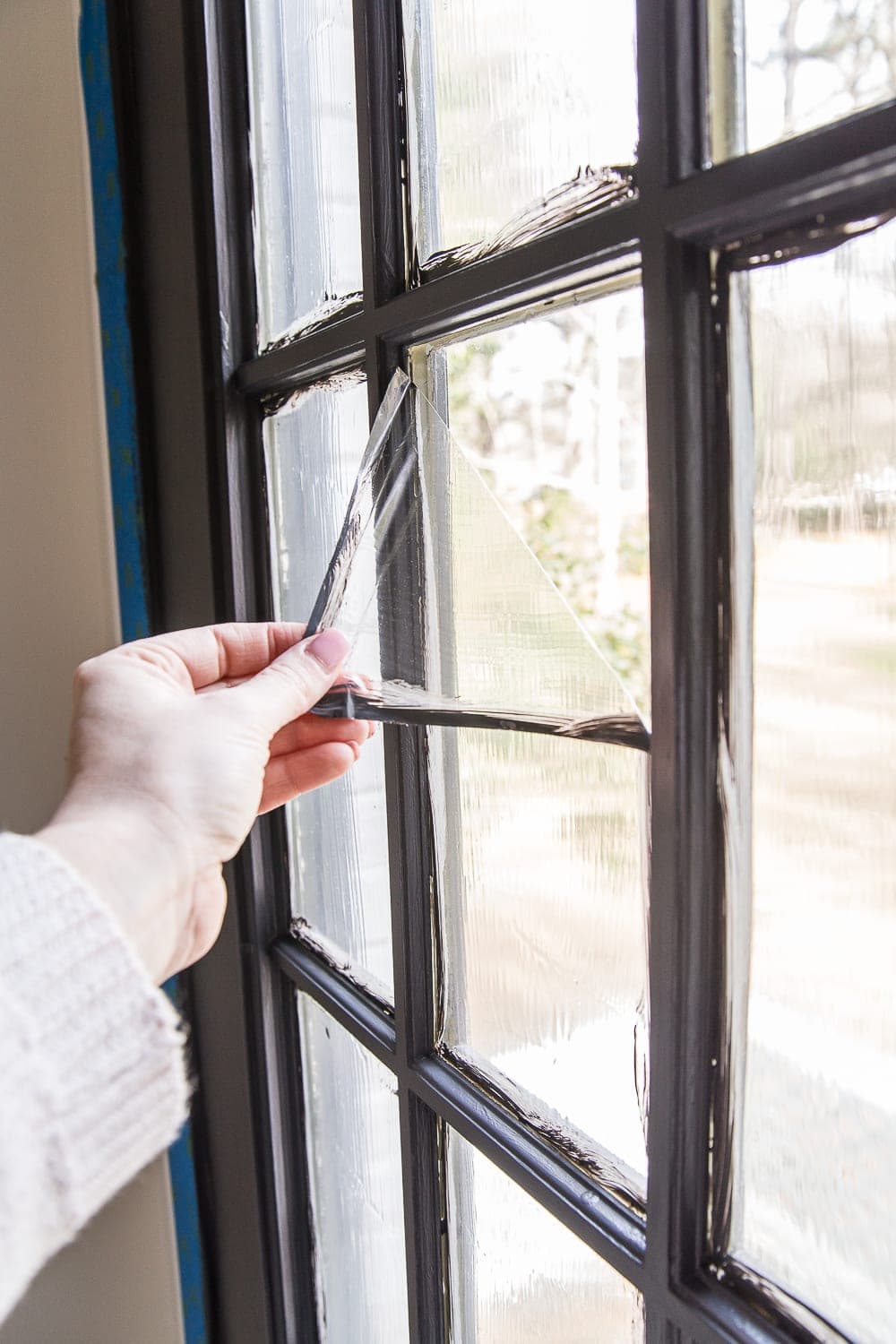 peeling masking liquid away from a french door window pane