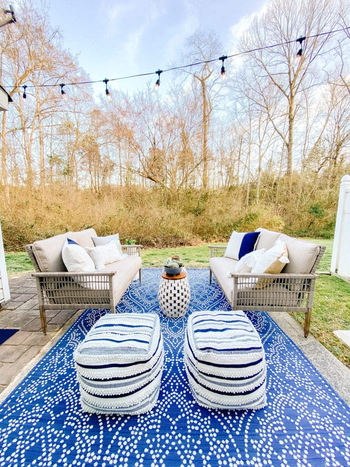outdoor rug and patio sofas on patio with string lights