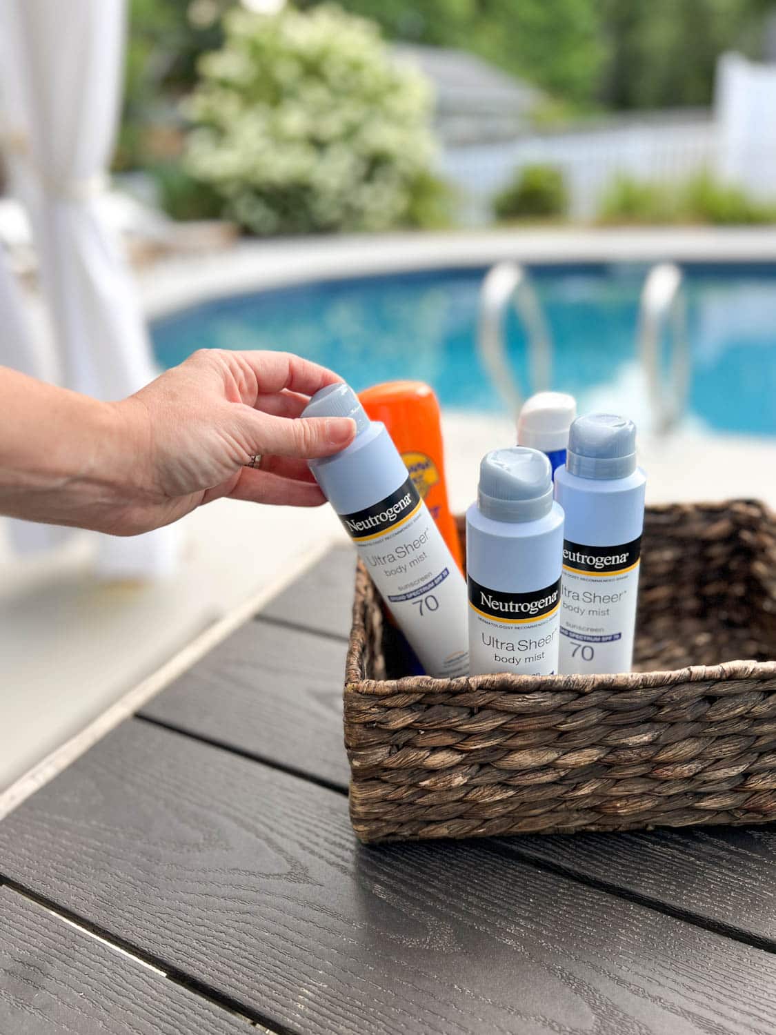 sunscreen basket provided for backyard pool party for guests to use