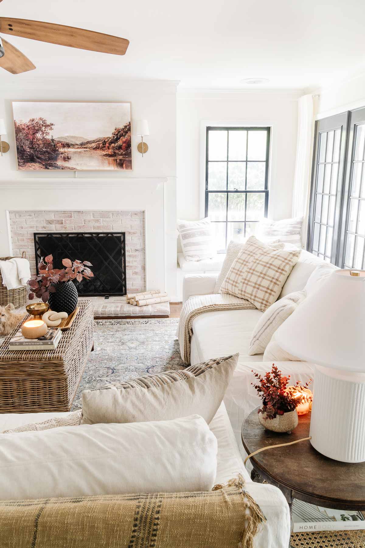 white slipcovered slope arm york pottery barn sofa with fall decor in living room