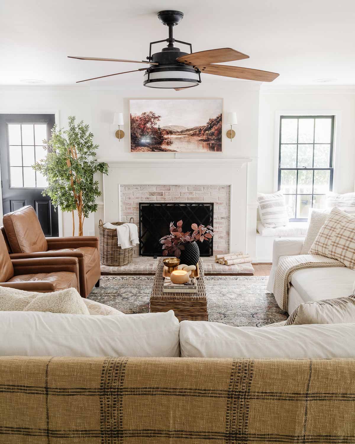 pottery barn sofa and recliners in living room with samsung frame tv