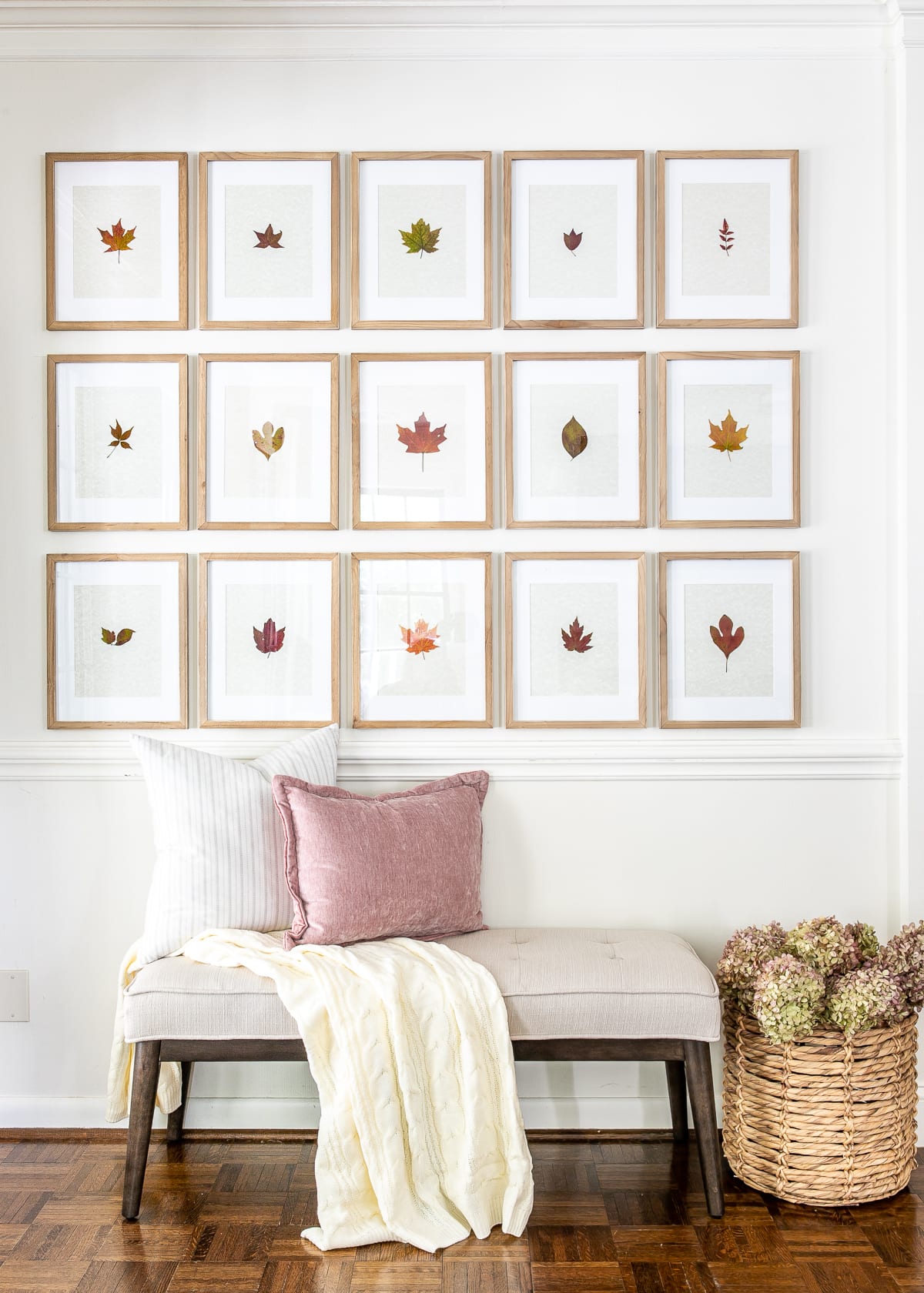 fall entryway with bench and pressed leaf gallery wall