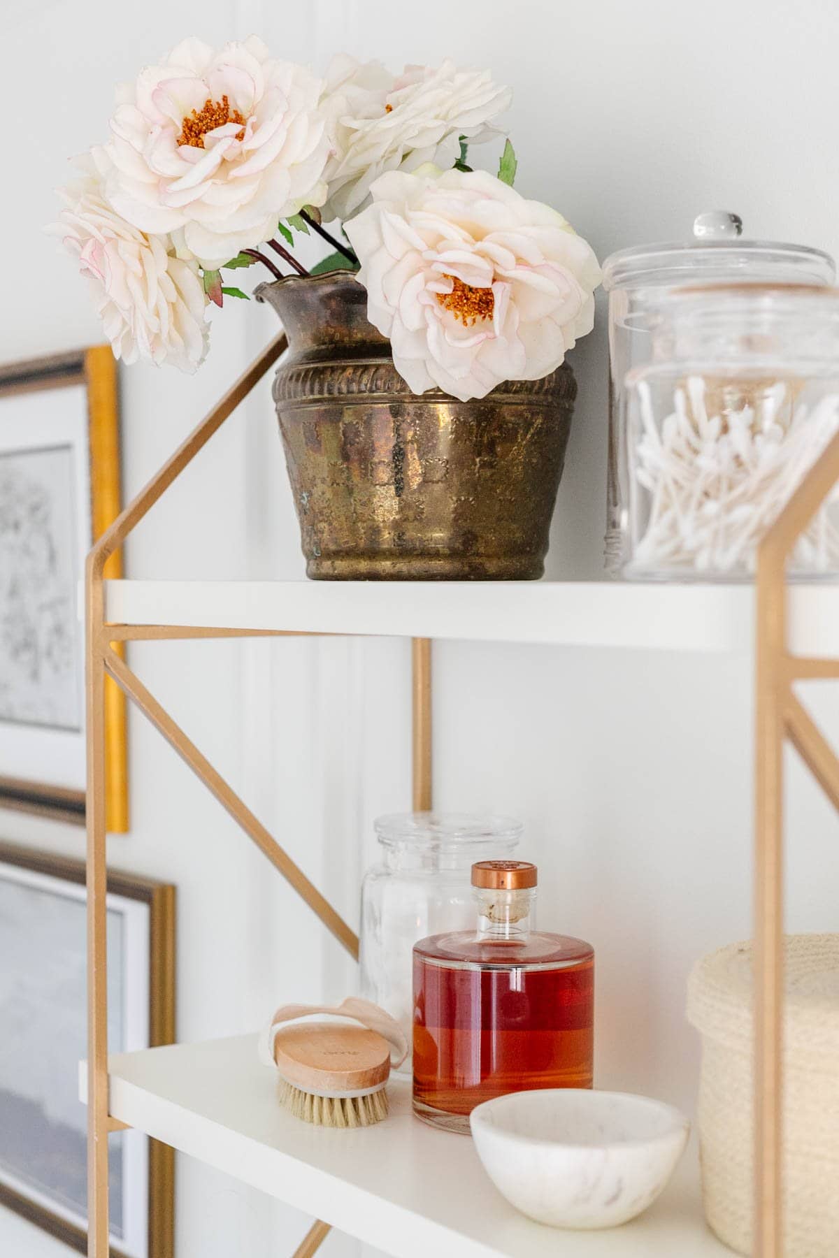 fake roses in a brass planter